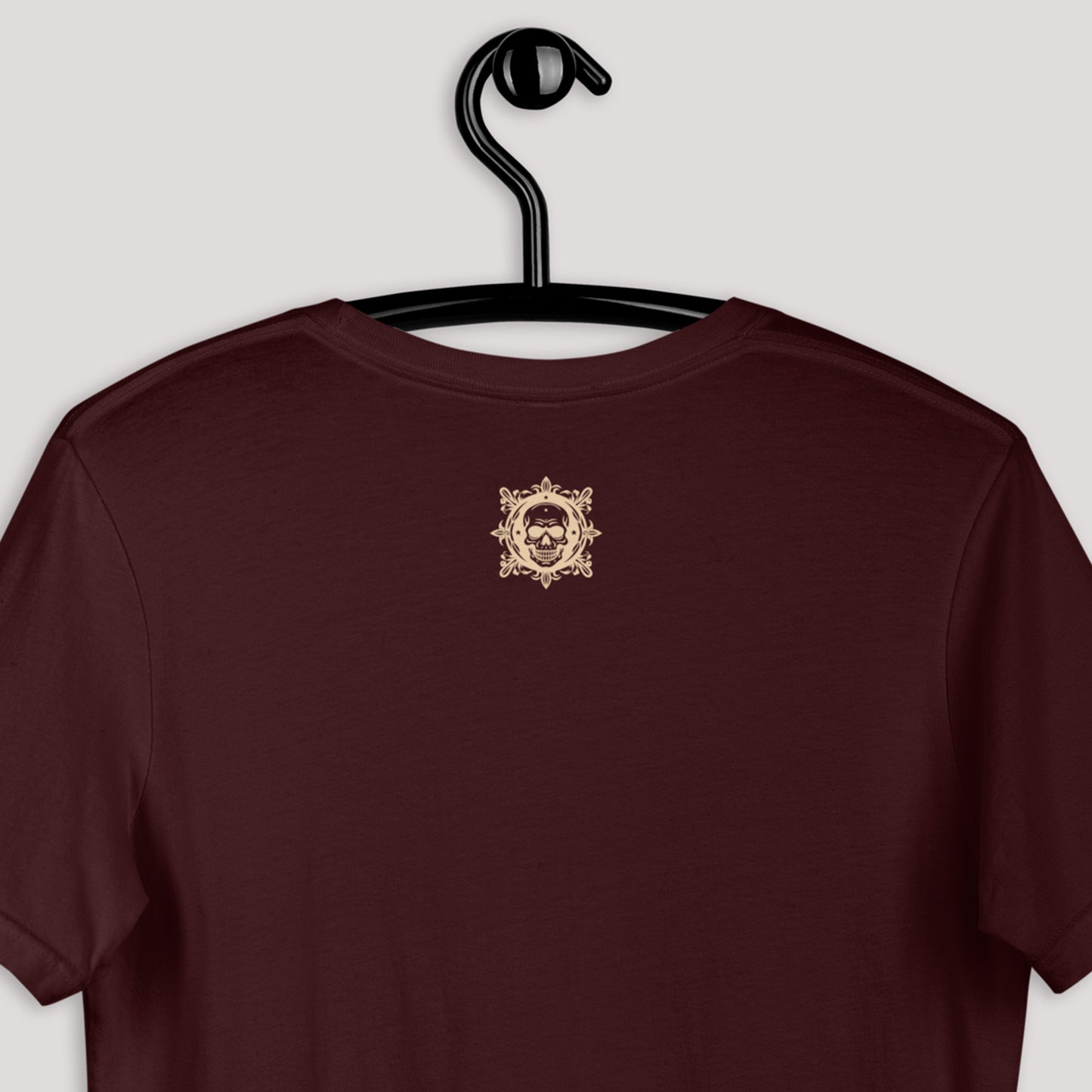 closeup of back logo on Dairy Doll Unisex t-shirt in oxblood black