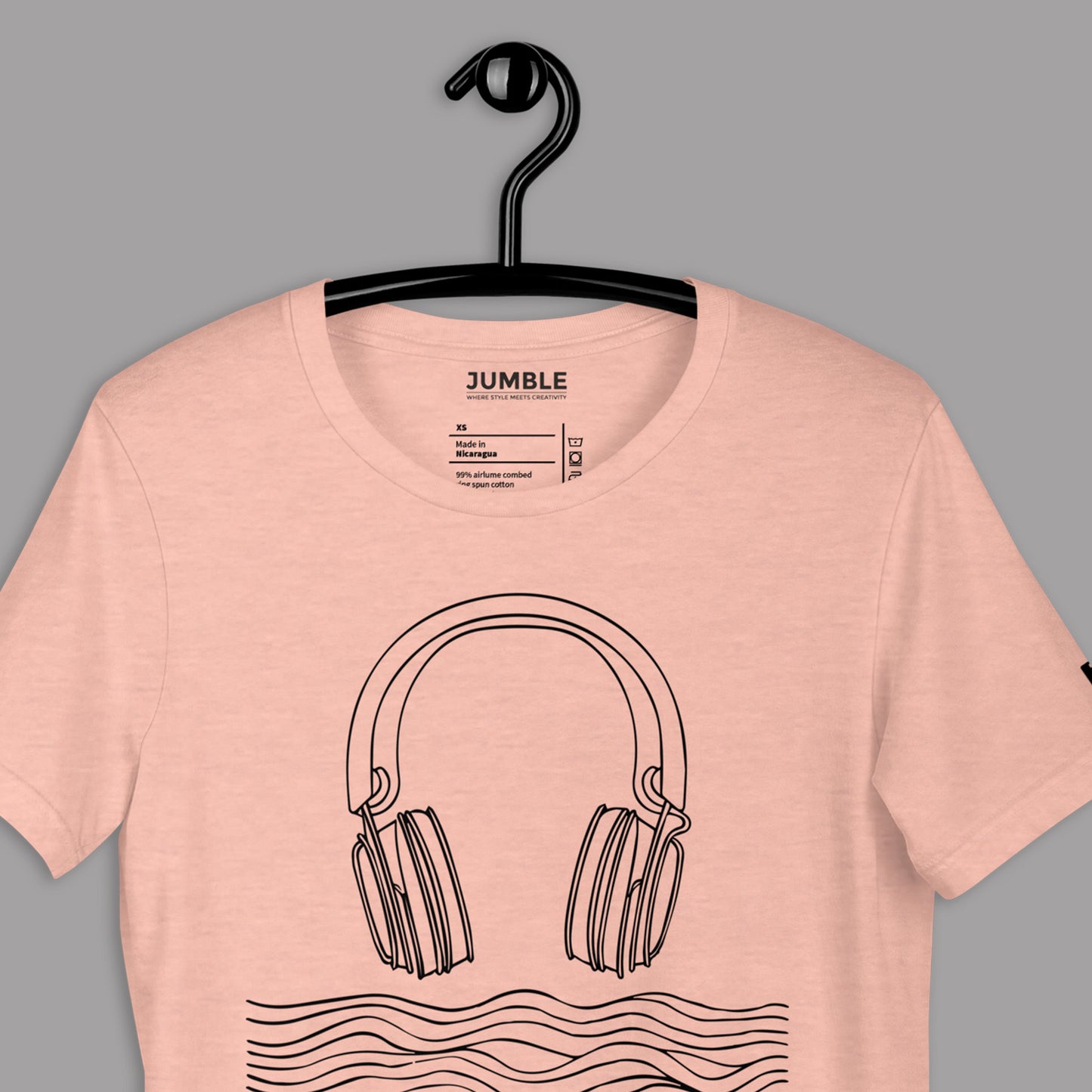 closeup of heather prism peach Tidal Beat Unisex t-shirt on a hanger