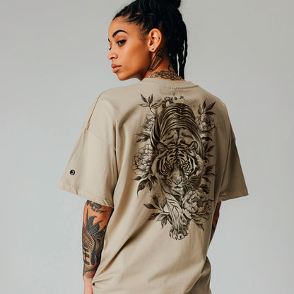 back view of female model wearing khaki Savage Bloom Oversized faded t-shirt (back print)