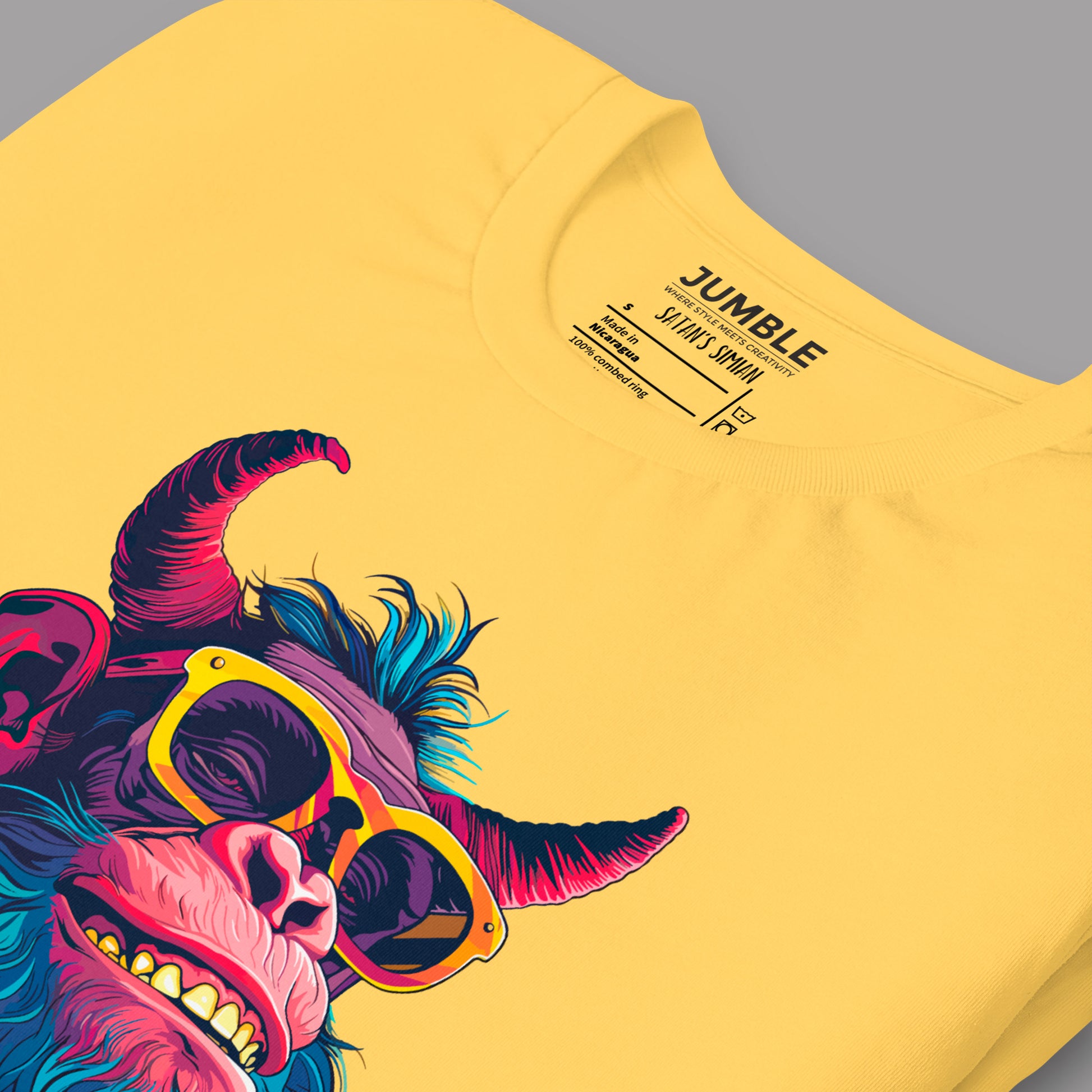 closeup of  yellow Satan's Simian Unisex t-shirt folded