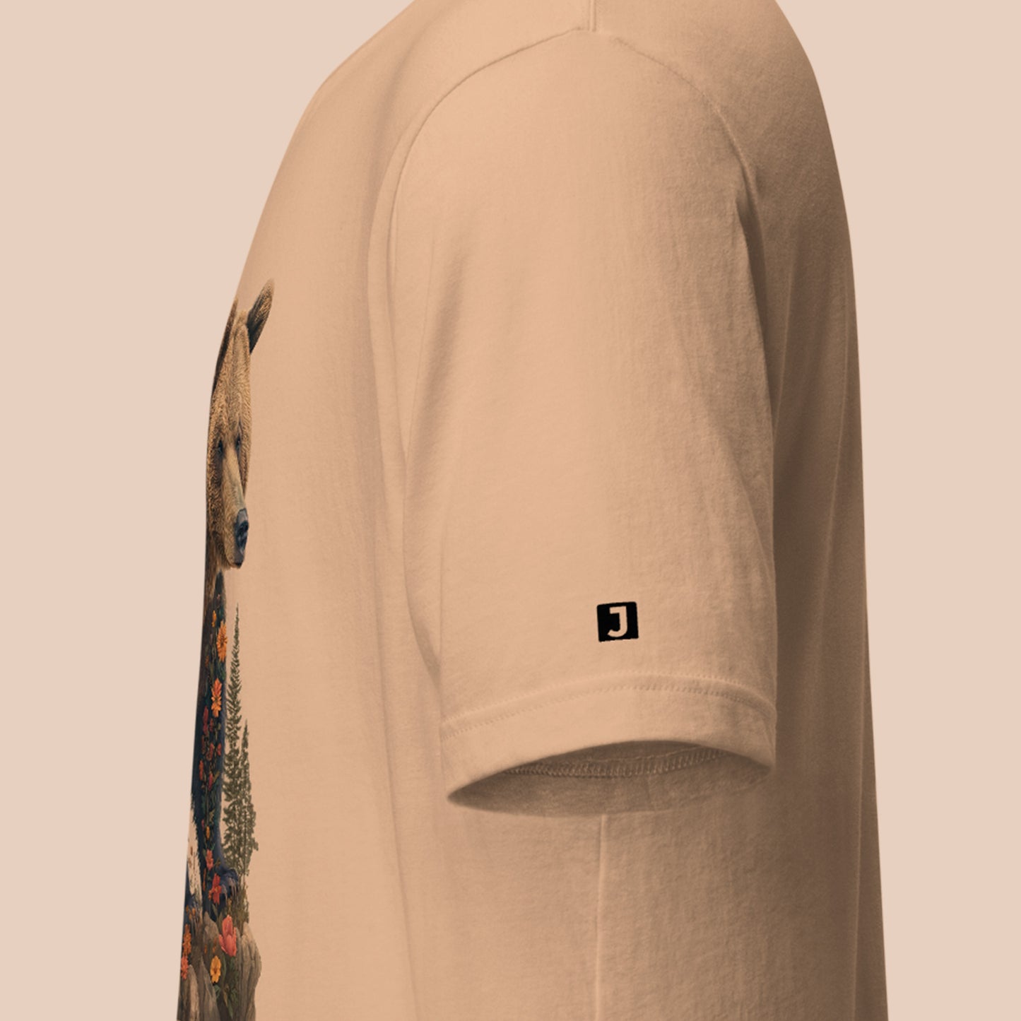 left sleeve logo on a tan Wildflowered Bruin Unisex t-shirt 