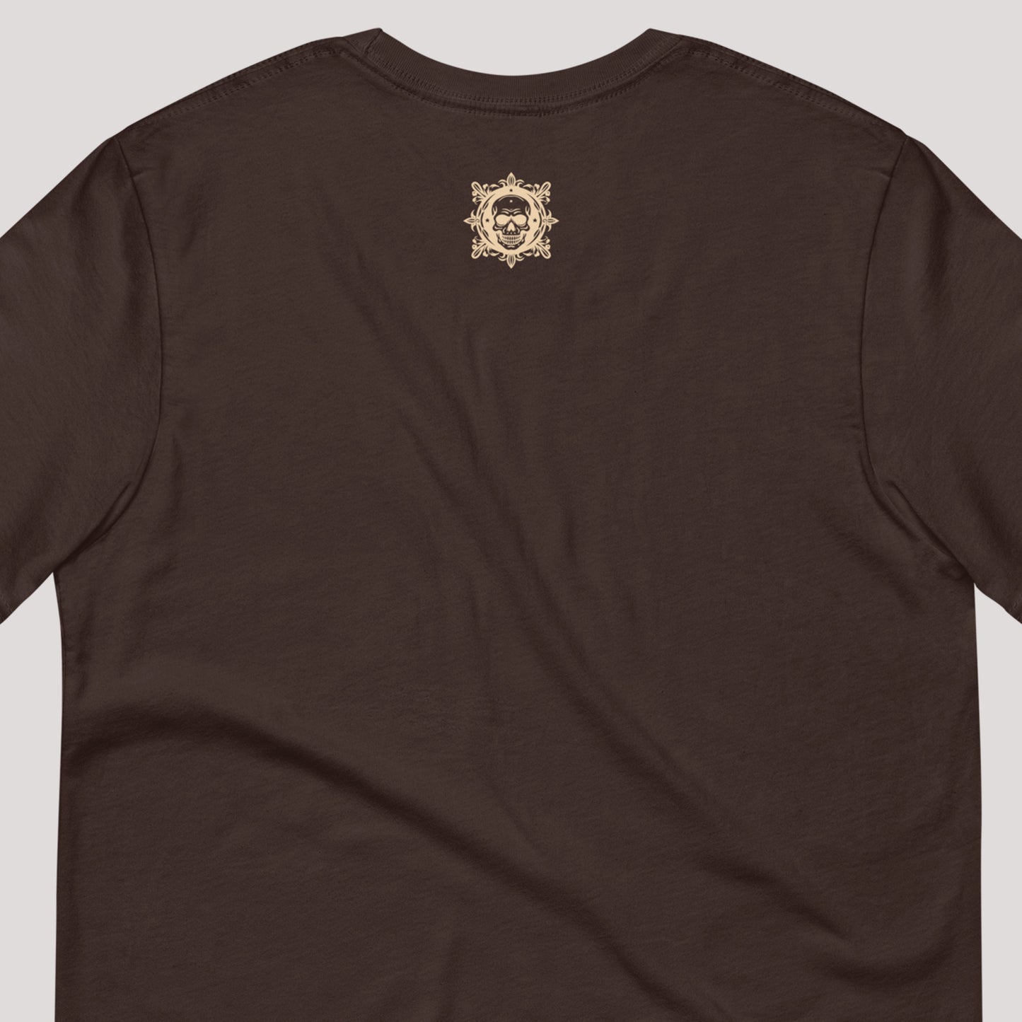 closeup of skull art on back of brown Coiled Grace Unisex t-shirt