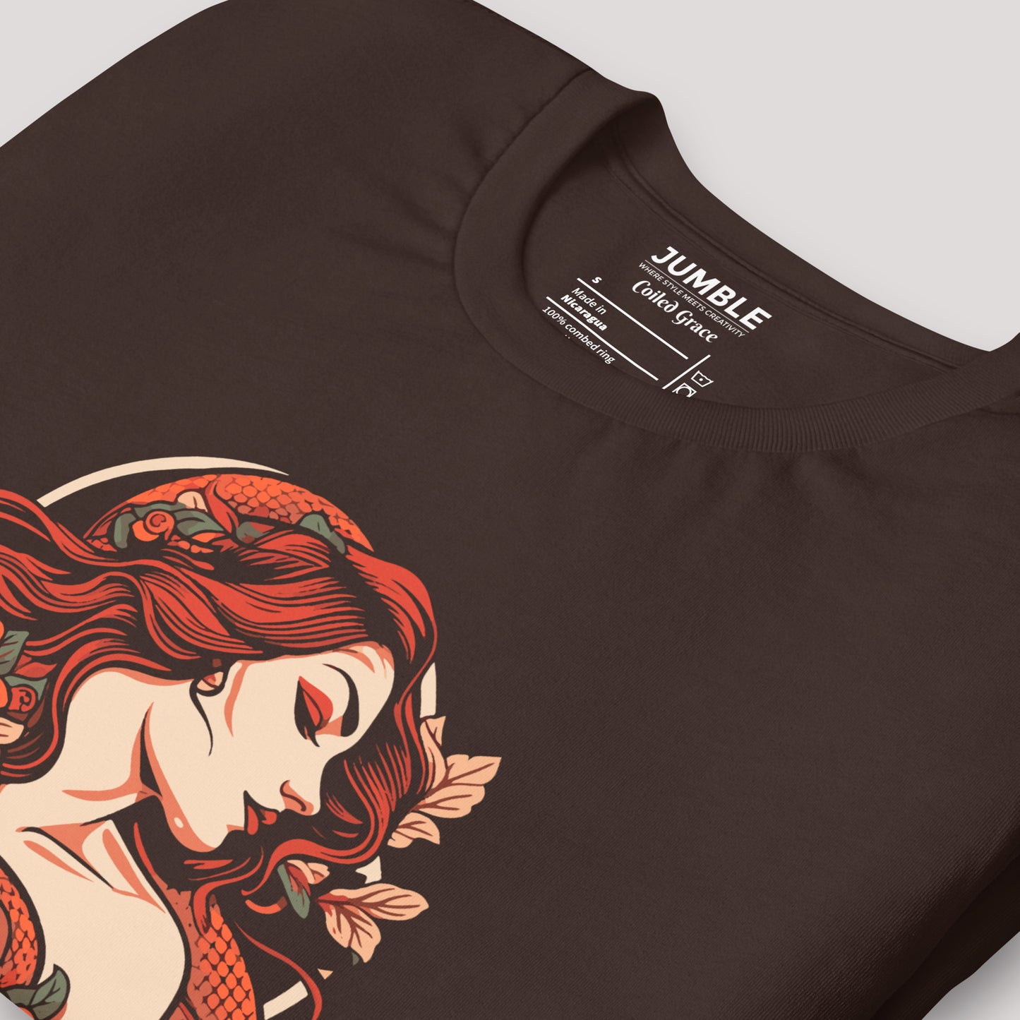 closeup of folded brown Coiled Grace Unisex t-shirt