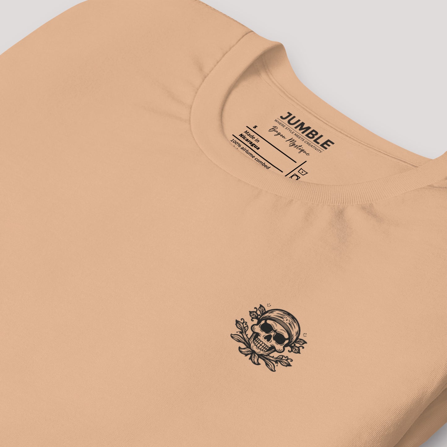 close up of a folded tan Bayou Mystique Unisex t-shirt
