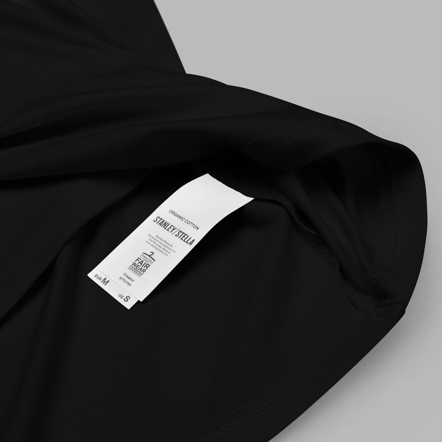 closeup of organic cotton label on a black Fungal Network Unisex organic cotton t-shirt