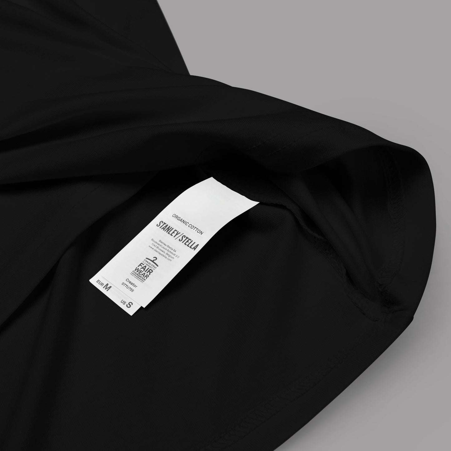 closeup or organic cotton label on a black Black Siren Unisex organic cotton t-shirt