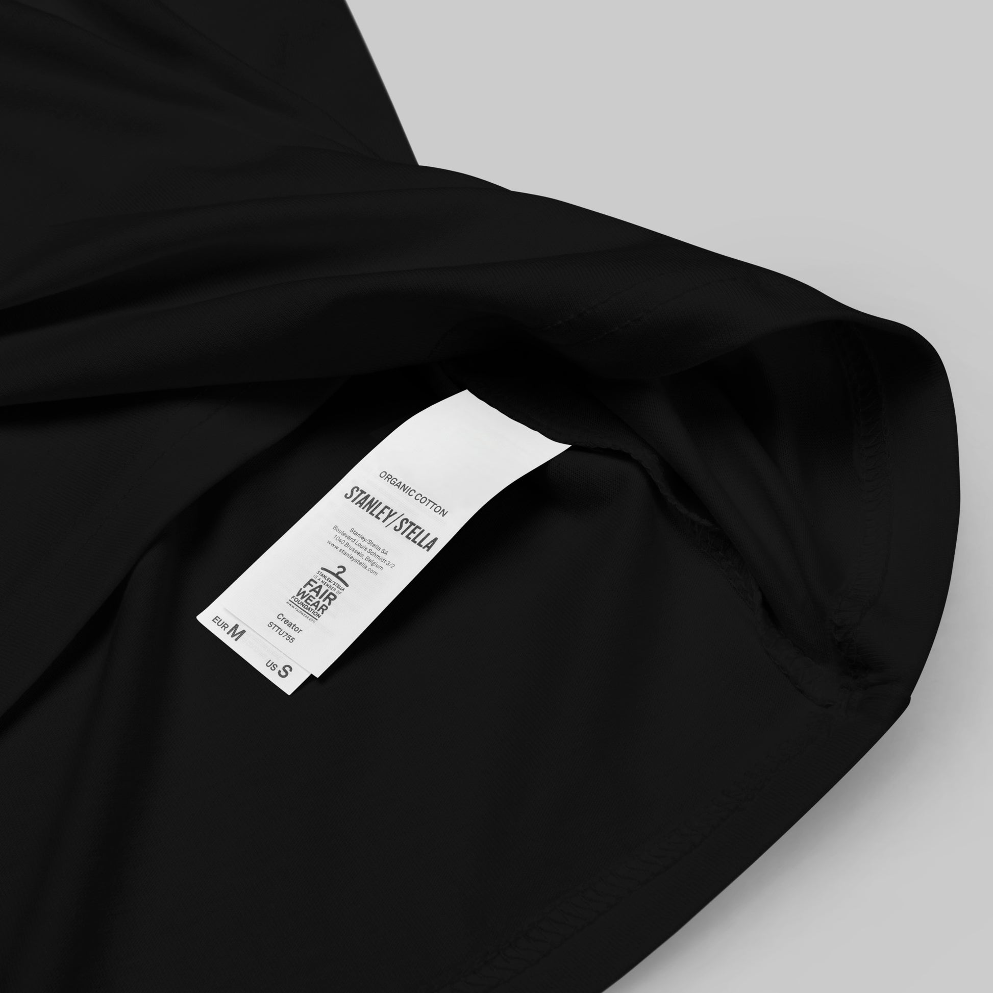 closeup of organic cotton label on a black Ka Manō Unisex organic cotton t-shirt