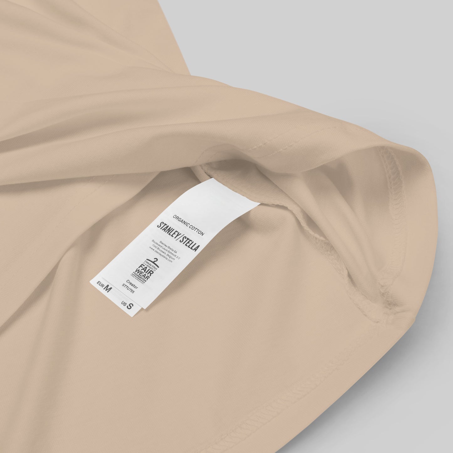 closeup of label on desert dust Ivory Guard Unisex organic cotton t-shirt