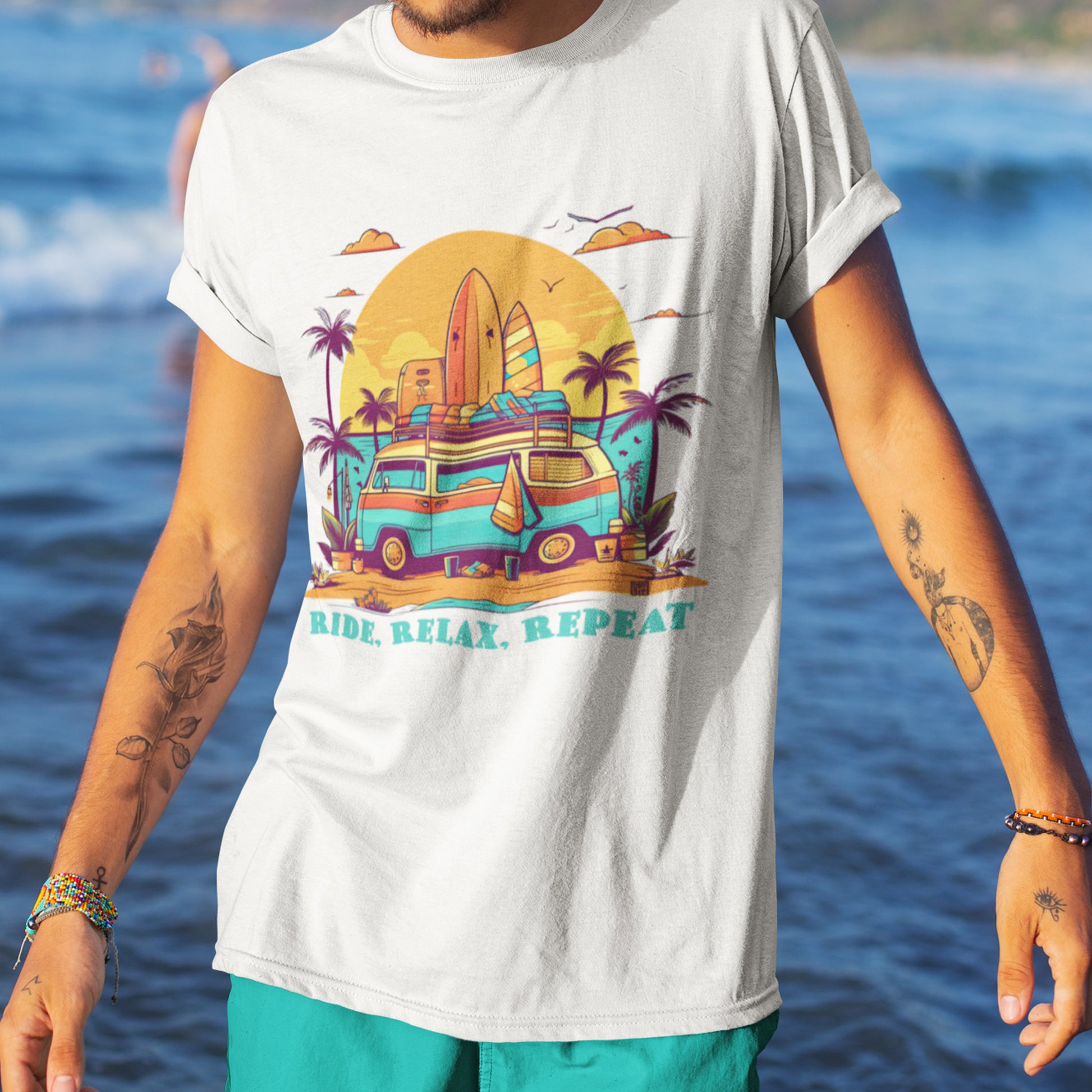 Male model wearing Unisex "Ride, Relax, Repeat" T-Shirt in White on a beach.