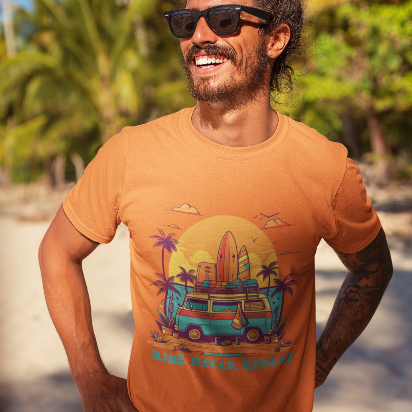 Male model wearing Unisex "Ride, Relax, Repeat" T-Shirt in Burnt Orange on a beach
