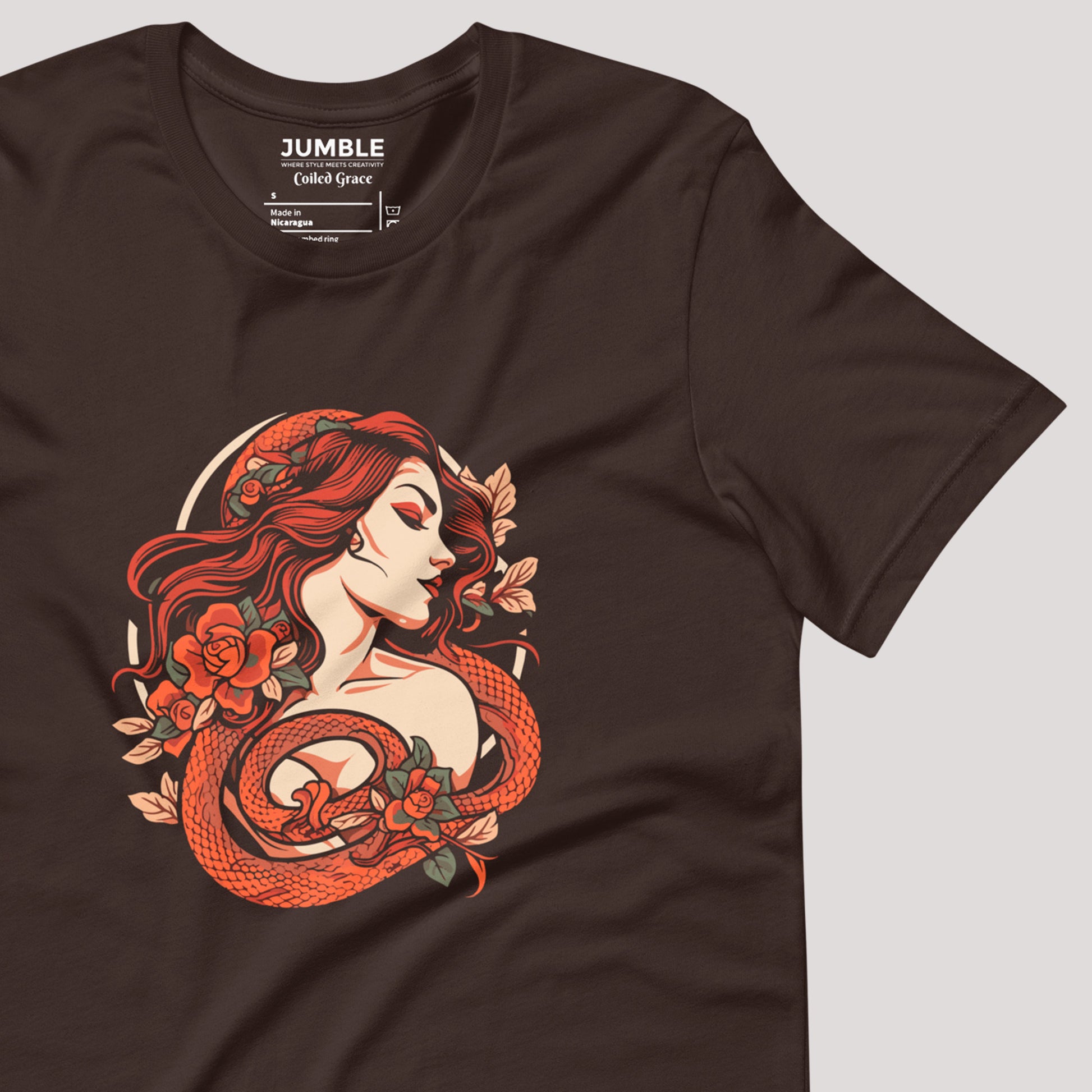 closeup of art on a brown Coiled Grace Unisex t-shirt
